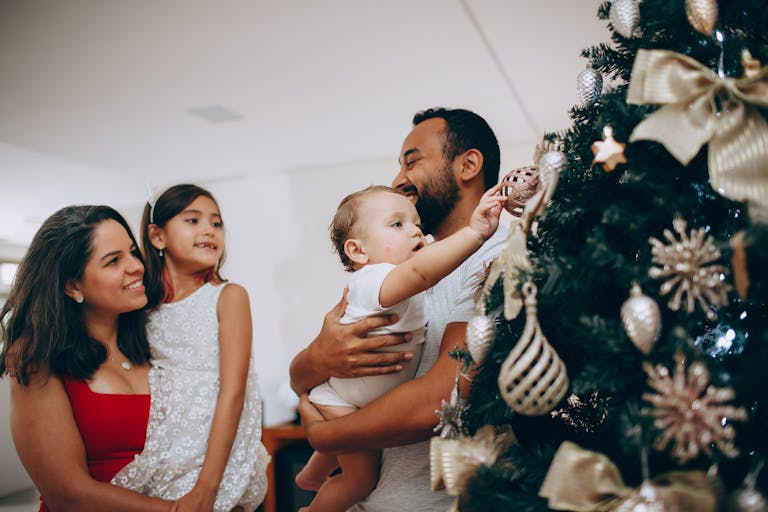 Holiday transitions with Joyful family bonding while decorating a Christmas tree at home but might need child therapy.